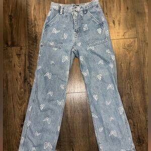 Simple Society wide leg light wash jeans with butterfly print